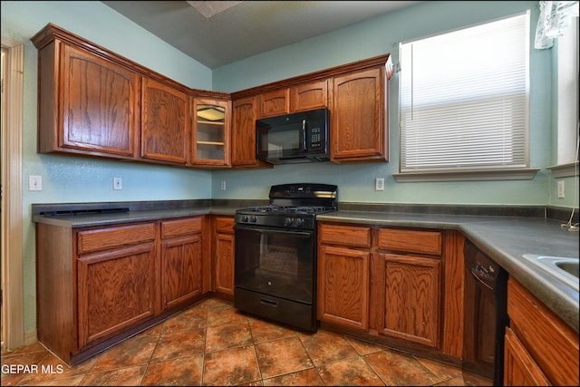 3517 Tierra Bahia Dr, El Paso, TX 79938 - kitchen with black appliances, dark countertops, and brown cabinets