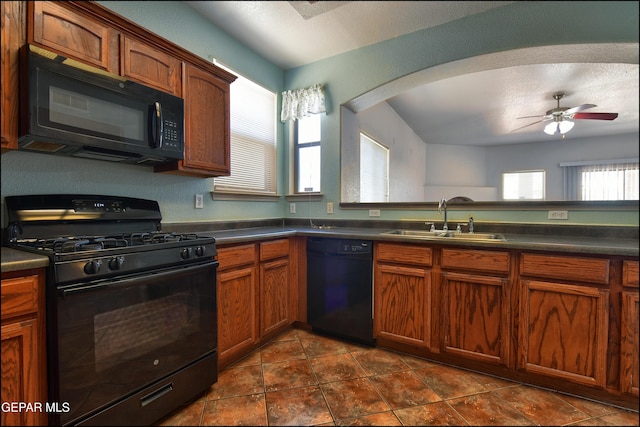 3517 Tierra Bahia Dr, El Paso, TX 79938 - kitchen featuring black appliances, ceiling fan, dark countertops, and brown cabinetry