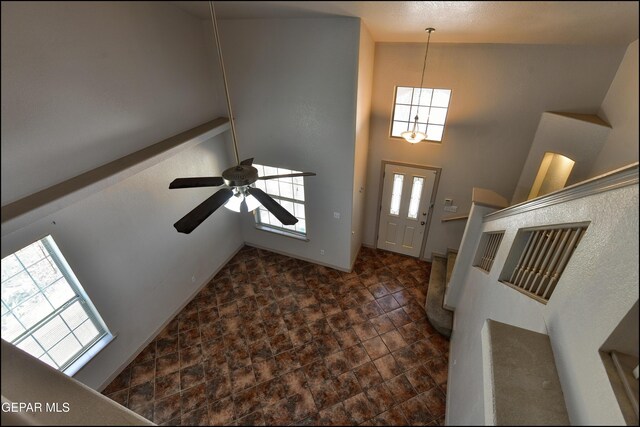 3517 Tierra Bahia Dr, El Paso, TX 79938 - foyer with a high ceiling, dark stone finish flooring, a chandelier, and ceiling fan