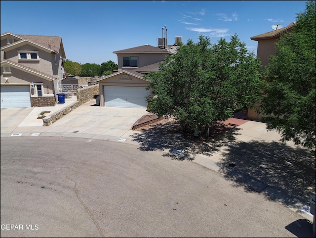 3517 Tierra Bahia Dr, El Paso, TX 79938 - view of front of house with concrete driveway, stucco siding, and an attached garage