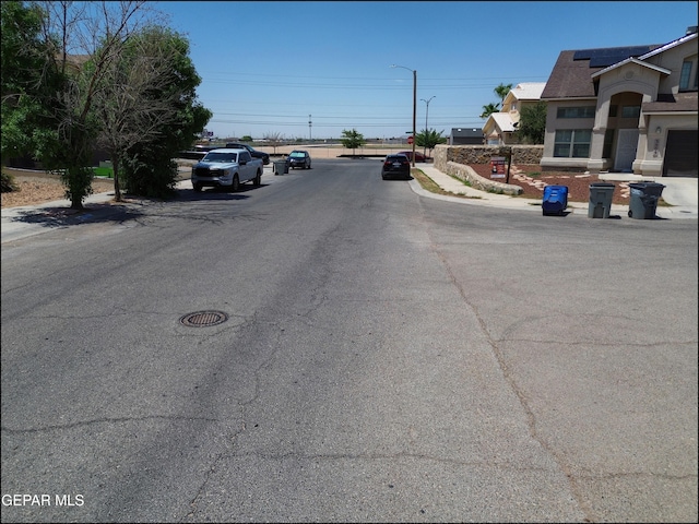 3517 Tierra Bahia Dr, El Paso, TX 79938 - view of asphalt street featuring sidewalks, street lights, and curbs