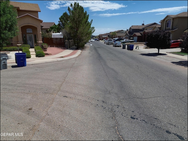 3517 Tierra Bahia Dr, El Paso, TX 79938 - view of asphalt street featuring a residential view, sidewalks, and curbs