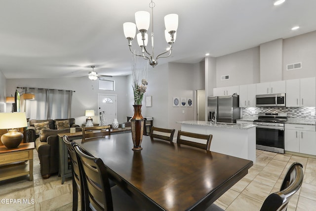 14744 Charles Foster Ave, El Paso, TX 79938 - dining room featuring ceiling fan, vaulted ceiling, a chandelier, and recessed lighting