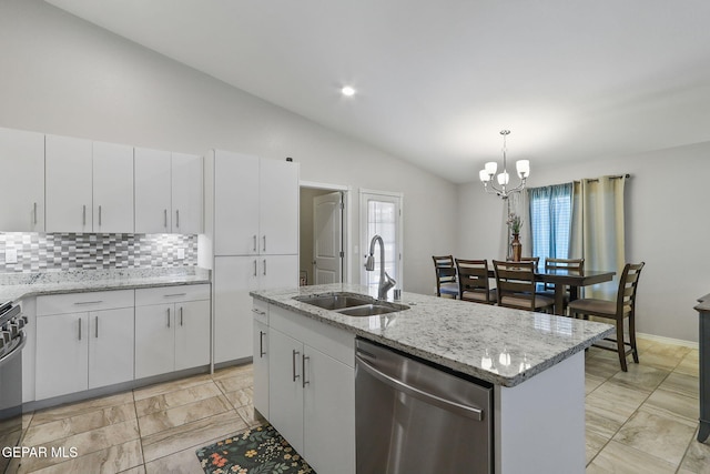 14744 Charles Foster Ave, El Paso, TX 79938 - kitchen with stainless steel appliances, lofted ceiling, tasteful backsplash, a chandelier, and white cabinetry