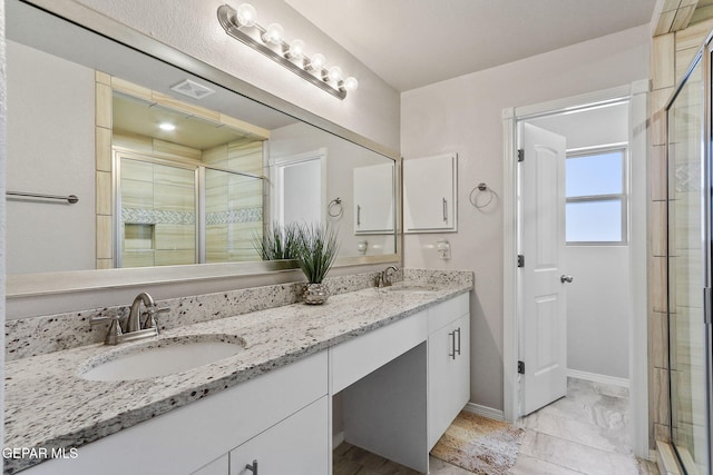 14744 Charles Foster Ave, El Paso, TX 79938 - full bathroom featuring double vanity, a shower stall, and marble look tile flooring