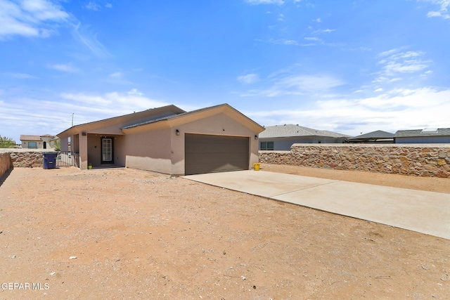 14744 Charles Foster Ave, El Paso, TX 79938 - view of side of home with driveway, an attached garage, and stucco siding