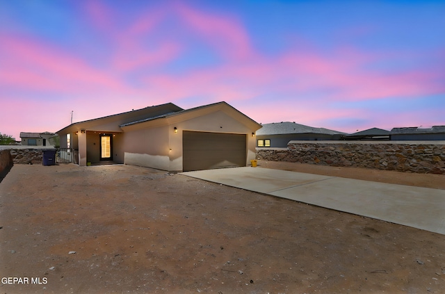 14744 Charles Foster Ave, El Paso, TX 79938 - view of front of house with driveway, an attached garage, and stucco siding