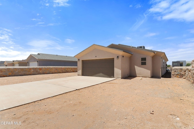 14744 Charles Foster Ave, El Paso, TX 79938 - view of front of property featuring stucco siding, concrete driveway, and an attached garage