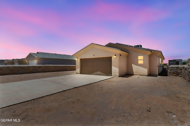 14744 Charles Foster Ave, El Paso, TX 79938 - view of front of property featuring stucco siding, driveway, and a garage