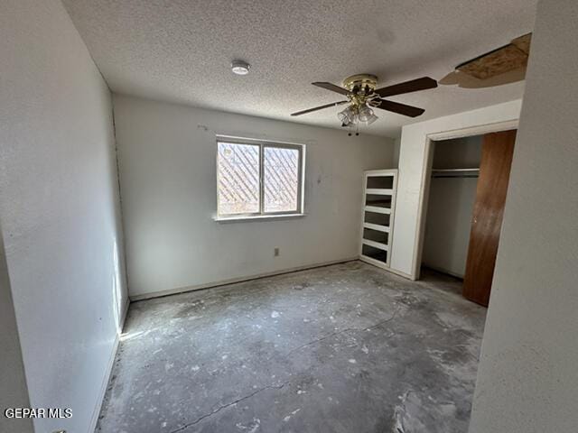 209 Durrill Rd, El Paso, TX 79915 - unfurnished bedroom with a textured ceiling, unfinished concrete floors, ceiling fan, and a closet
