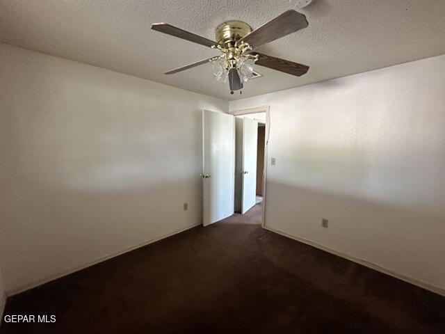 209 Durrill Rd, El Paso, TX 79915 - spare room with ceiling fan, dark colored carpet, and a textured ceiling