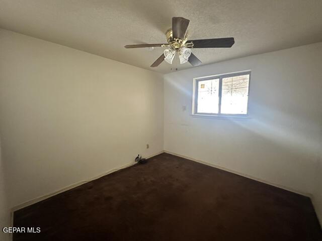 209 Durrill Rd, El Paso, TX 79915 - empty room featuring dark colored carpet and ceiling fan