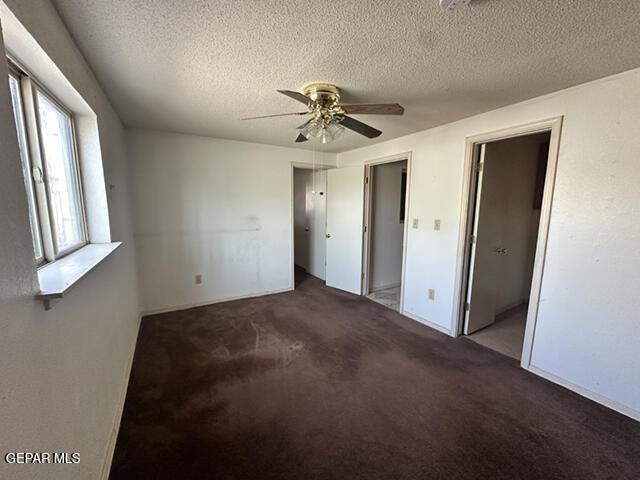 209 Durrill Rd, El Paso, TX 79915 - unfurnished bedroom featuring a textured ceiling, carpet, and ceiling fan
