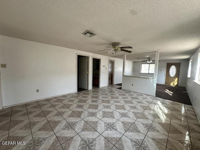 209 Durrill Rd, El Paso, TX 79915 - unfurnished living room with a textured ceiling and ceiling fan