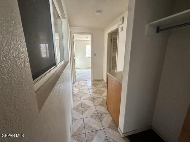 209 Durrill Rd, El Paso, TX 79915 - hallway featuring light tile patterned floors