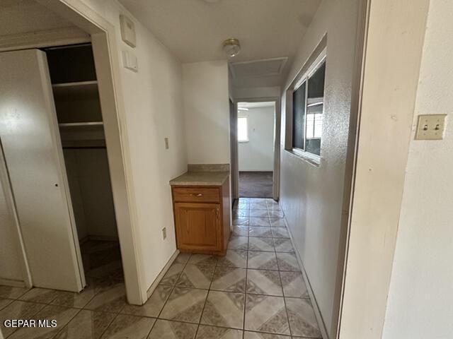 209 Durrill Rd, El Paso, TX 79915 - corridor featuring attic access and light tile patterned floors