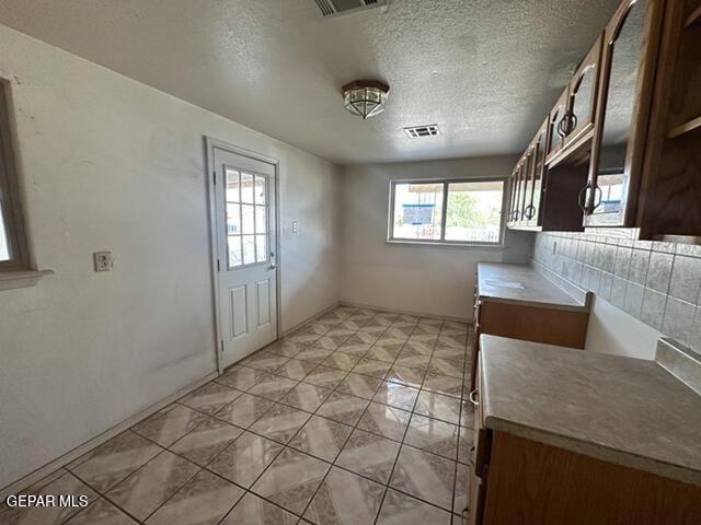 209 Durrill Rd, El Paso, TX 79915 - unfurnished dining area featuring a textured ceiling and light tile patterned flooring