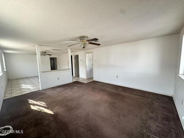 209 Durrill Rd, El Paso, TX 79915 - unfurnished living room featuring carpet flooring, ceiling fan, a textured ceiling, and tile patterned flooring