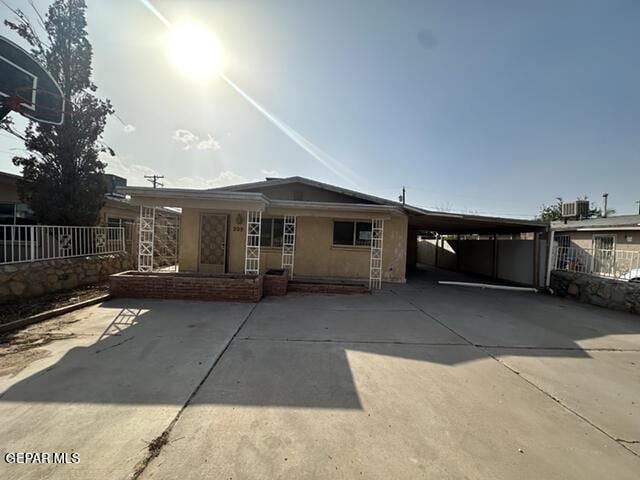 209 Durrill Rd, El Paso, TX 79915 - rear view of property featuring a carport, concrete driveway, and a porch