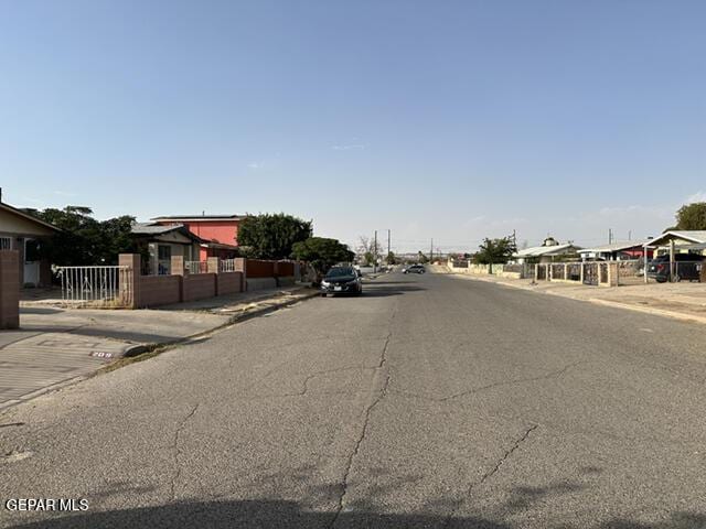 209 Durrill Rd, El Paso, TX 79915 - view of asphalt road featuring sidewalks and curbs