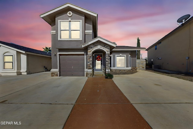 4640 Beacham St, El Paso, TX 79938 - view of front of property with driveway, stucco siding, stone siding, and a garage