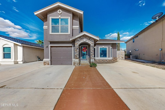 4640 Beacham St, El Paso, TX 79938 - view of front facade featuring stone siding, concrete driveway, stucco siding, and a garage