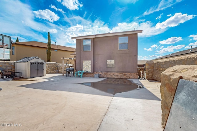 4640 Beacham St, El Paso, TX 79938 - rear view of property featuring a storage unit, a patio area, and stucco siding