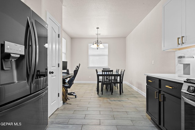12334 Westbury, El Paso, TX 79928 - kitchen with smart refrigerator, light countertops, pendant lighting, a textured ceiling, and a chandelier
