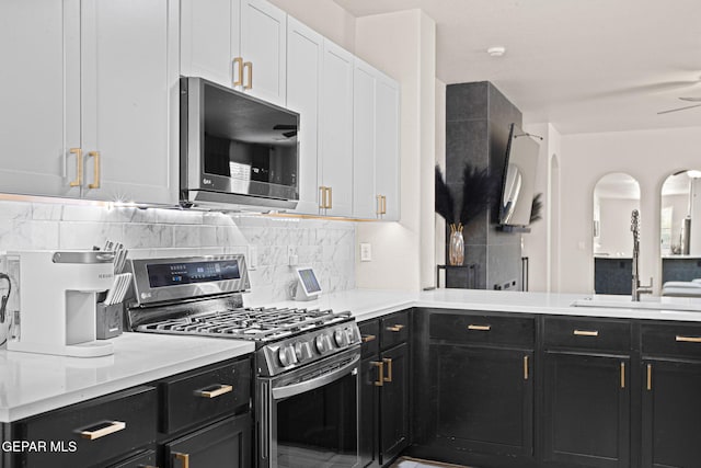 12334 Westbury, El Paso, TX 79928 - kitchen featuring stainless steel appliances, dark cabinetry, backsplash, and light countertops