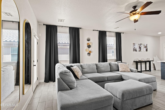12334 Westbury, El Paso, TX 79928 - living room with a ceiling fan, a textured ceiling, and light wood finished floors