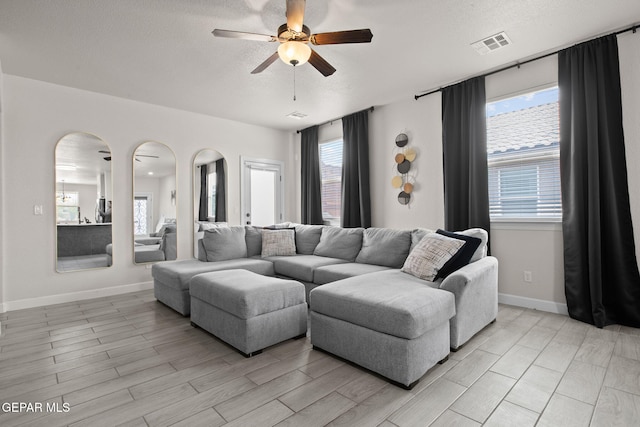 12334 Westbury, El Paso, TX 79928 - living area featuring a ceiling fan, plenty of natural light, a textured ceiling, and light wood-type flooring