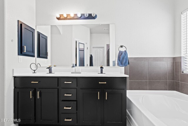 12334 Westbury, El Paso, TX 79928 - bathroom featuring a garden tub and double vanity
