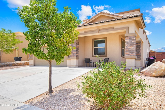 12334 Westbury, El Paso, TX 79928 - view of front of property with stucco siding, stone siding, concrete driveway, and an attached garage