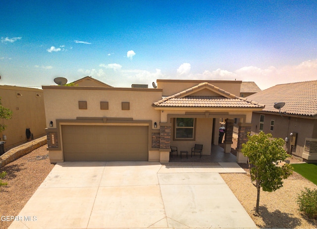 12334 Westbury, El Paso, TX 79928 - view of front of house with stucco siding, a tiled roof, concrete driveway, and an attached garage