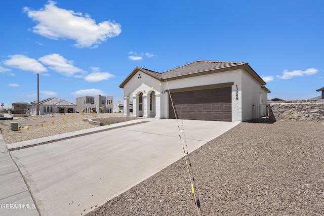 224 Penbridge Pl, El Paso, TX 79928 - view of front of property with concrete driveway, an attached garage, stucco siding, and a tiled roof