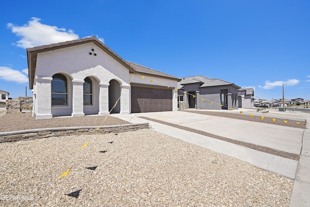 224 Penbridge Pl, El Paso, TX 79928 - view of front facade with concrete driveway, an attached garage, a tiled roof, and stucco siding