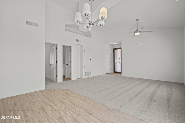 224 Penbridge Pl, El Paso, TX 79928 - unfurnished living room with ceiling fan, a chandelier, high vaulted ceiling, and wood finished floors