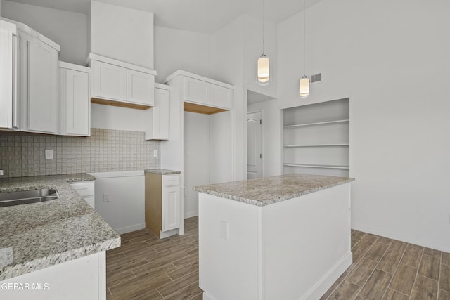 224 Penbridge Pl, El Paso, TX 79928 - kitchen featuring dark wood-style flooring, backsplash, white cabinets, and high vaulted ceiling