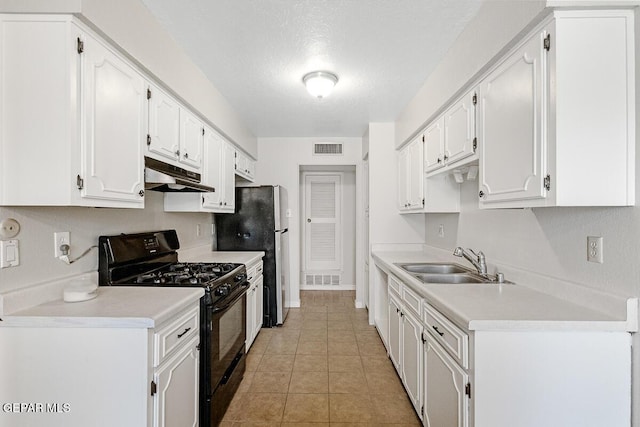 1615 Opossum Cir, Horizon City, TX 79928 - kitchen featuring black gas stove, white cabinets, under cabinet range hood, light countertops, and light tile patterned floors