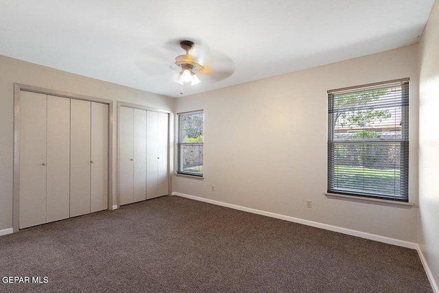 1615 Opossum Cir, Horizon City, TX 79928 - unfurnished bedroom featuring multiple windows, multiple closets, carpet, and a ceiling fan