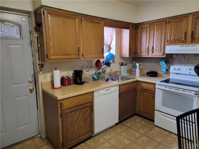 kitchen featuring ventilation hood, sink, and white appliances