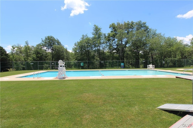 view of pool with a yard