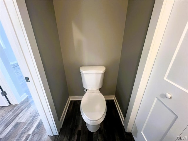 bathroom featuring hardwood / wood-style flooring and toilet