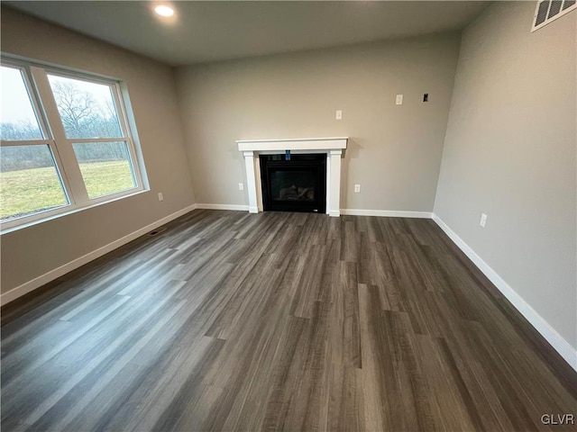 unfurnished living room featuring dark hardwood / wood-style flooring