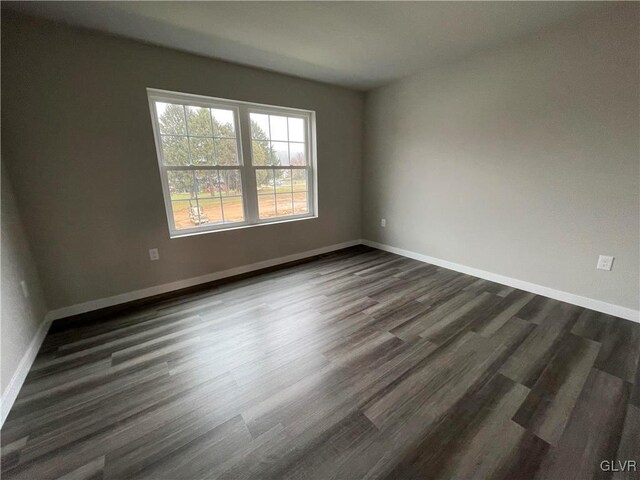 unfurnished room featuring dark hardwood / wood-style floors