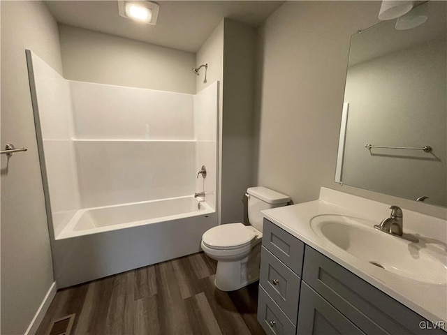 full bathroom featuring hardwood / wood-style floors, vanity,  shower combination, and toilet