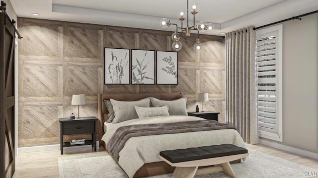 bedroom featuring a barn door, light hardwood / wood-style floors, an inviting chandelier, and wooden walls