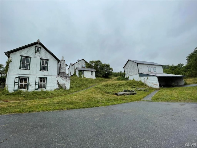 view of property exterior with a lawn