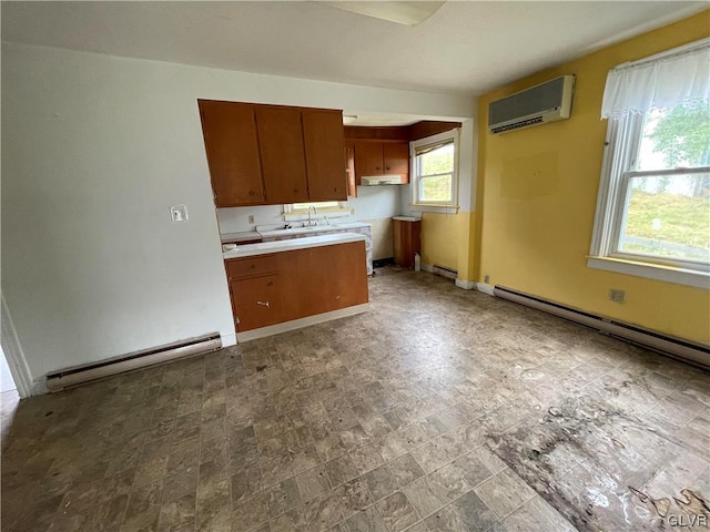 kitchen with a baseboard radiator, sink, and a wall mounted AC