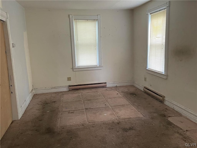 empty room with baseboard heating and plenty of natural light